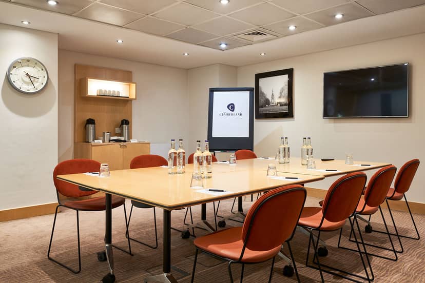 Meeting room in The Cumberland Hotel with large table and presentation technology.