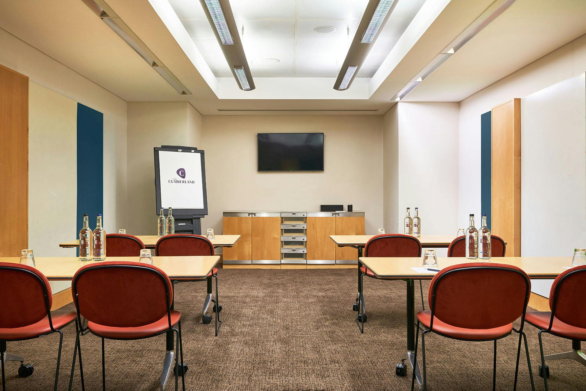 Meeting room in The Cumberland Hotel, featuring modern furnishings for corporate events.