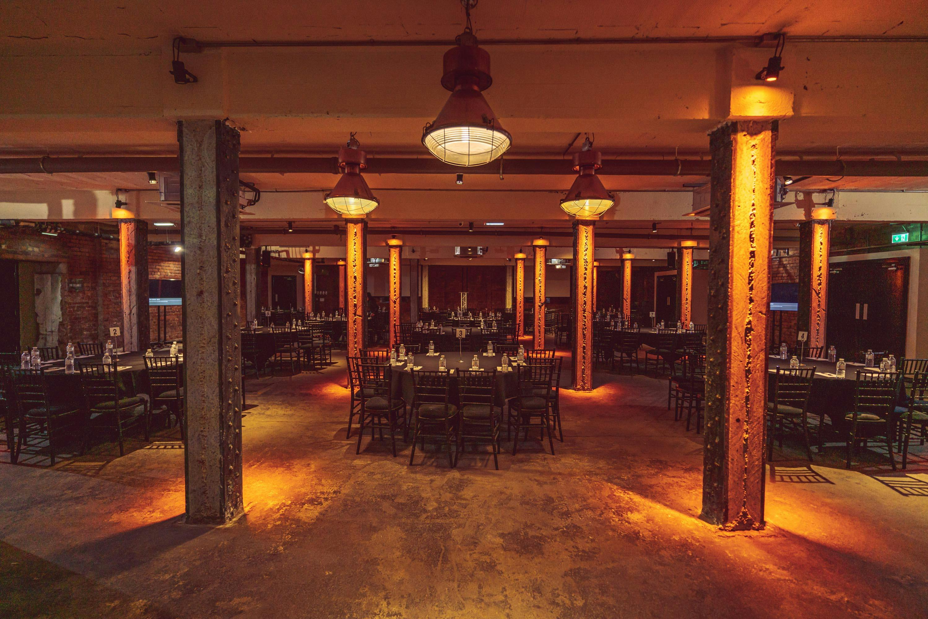 Versatile event space in Victoria Warehouse with exposed brick, ideal for corporate gatherings.