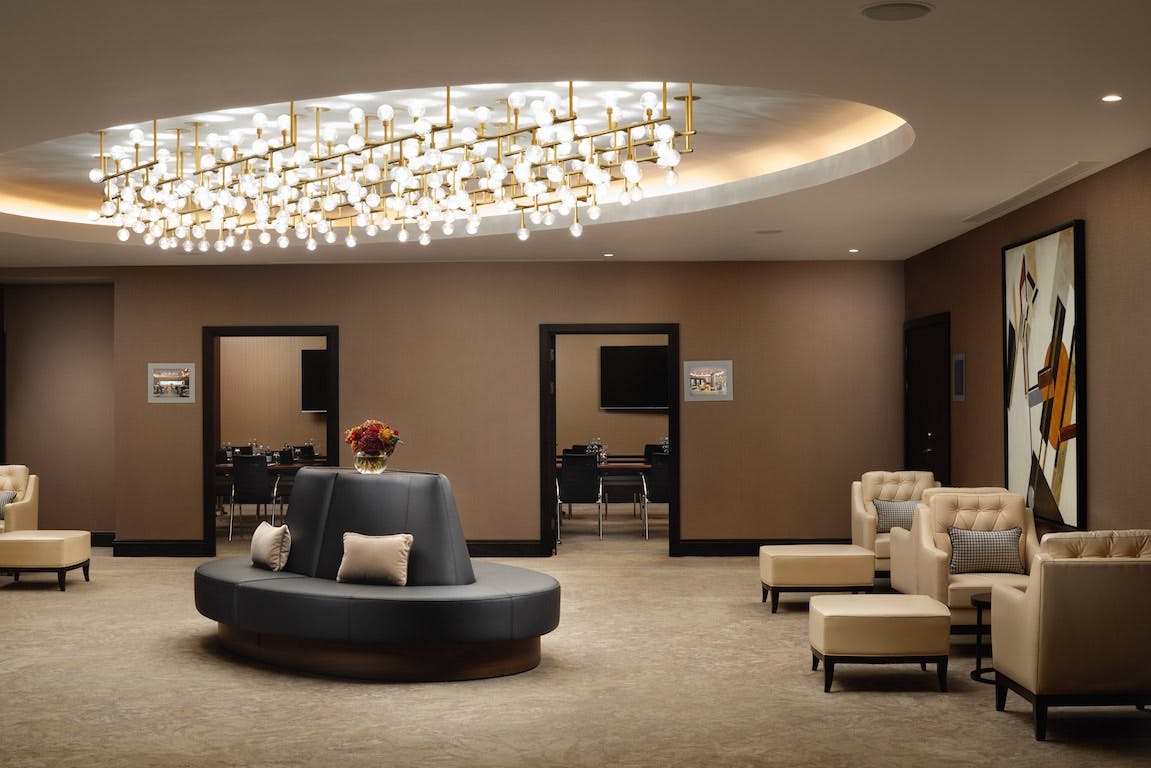 Elegant event space at Hilton London Bankside with modern chandelier, ideal for gatherings.