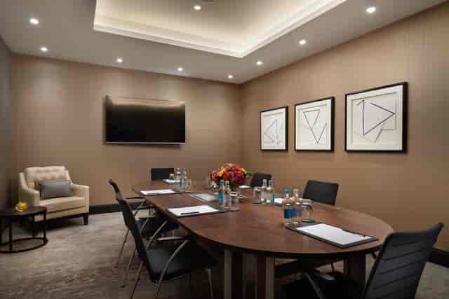 Modern meeting room at Hilton London Bankside with round table for professional events.