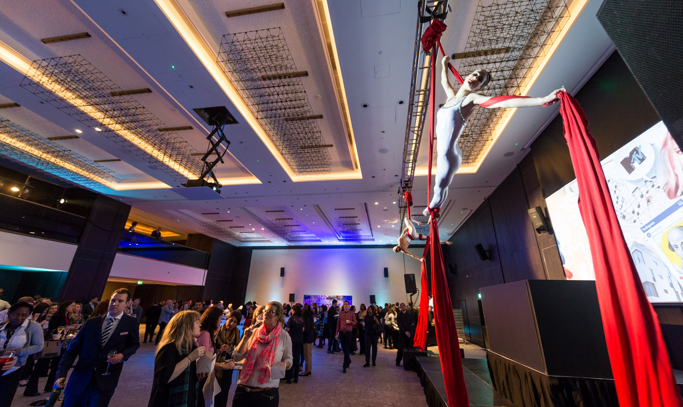 Aerial performers in elegant event space at Hilton London Bankside for corporate gatherings. - Banner
