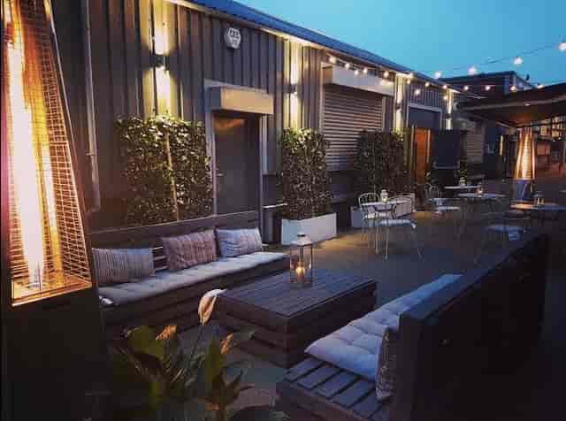 Industrial-chic New Craven Hall outdoor breakout space with cozy lounge seating for event venues.
