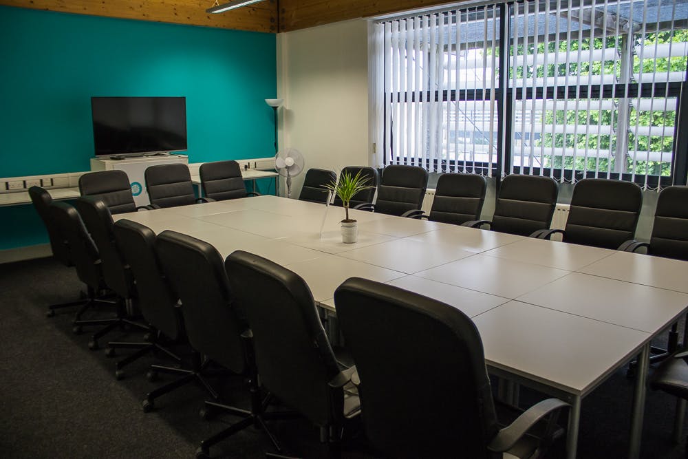 Modern conference room with spacious table, ideal for collaborative meetings and presentations.