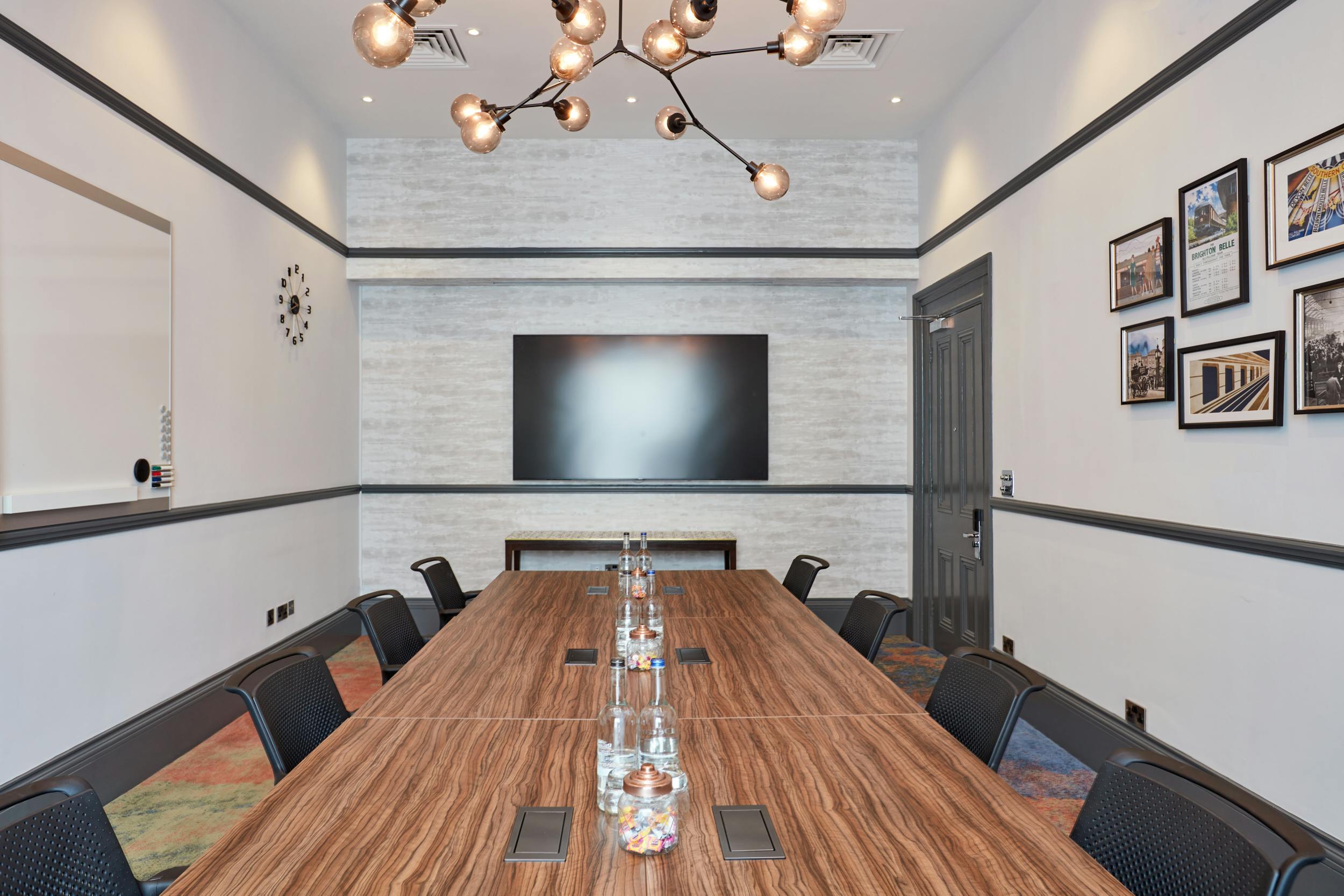 Modern conference room in The Clermont Victoria with a long wooden table and sleek chairs.