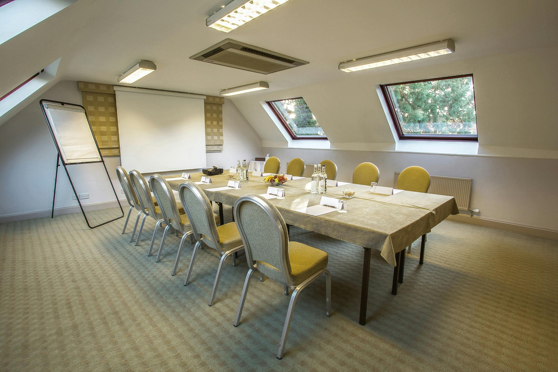 Rome Suite meeting room with long table, ideal for corporate events and presentations.