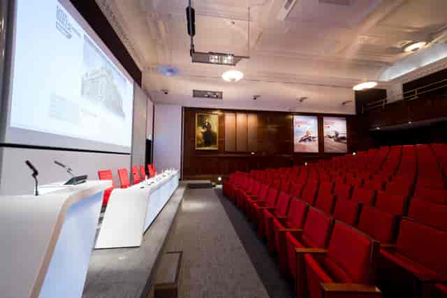 Lecture Theatre at One Birdcage Walk with red seating, ideal for corporate seminars.