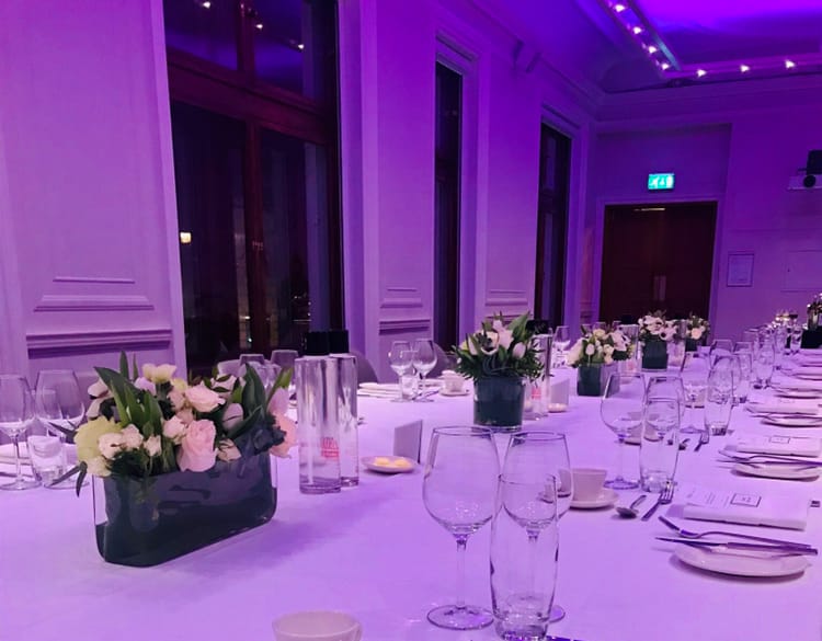 Elegant dining table with floral centerpieces for a corporate gala at One Birdcage Walk.