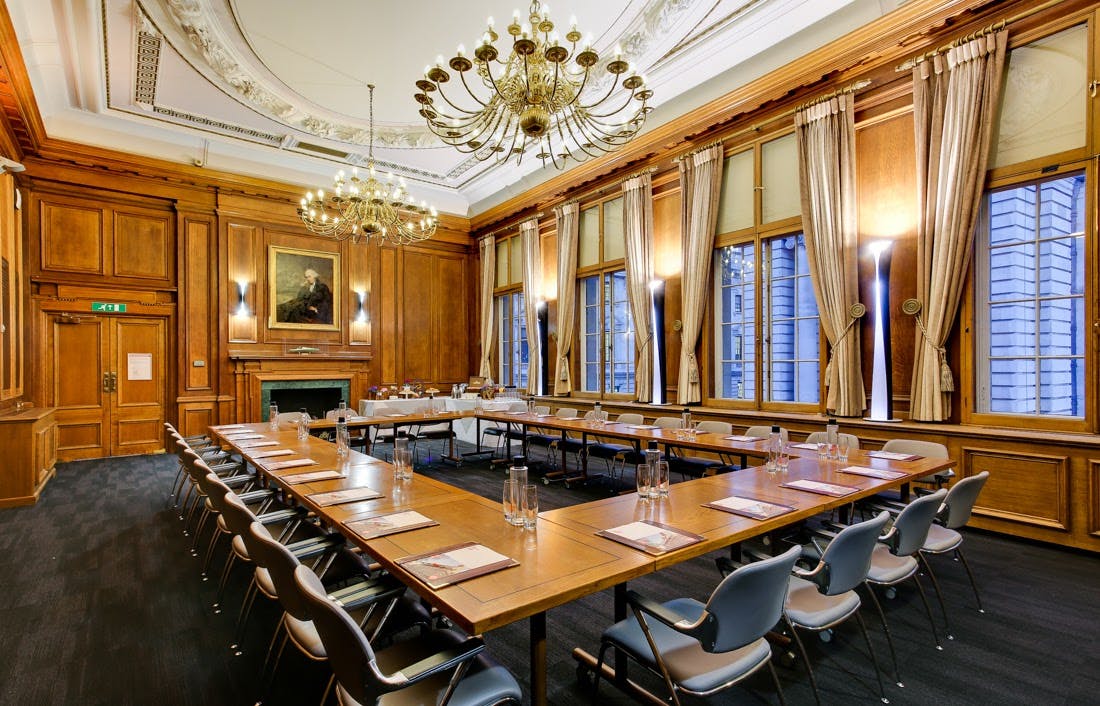 Sophisticated meeting room with wood paneling, ideal for corporate events and gatherings.