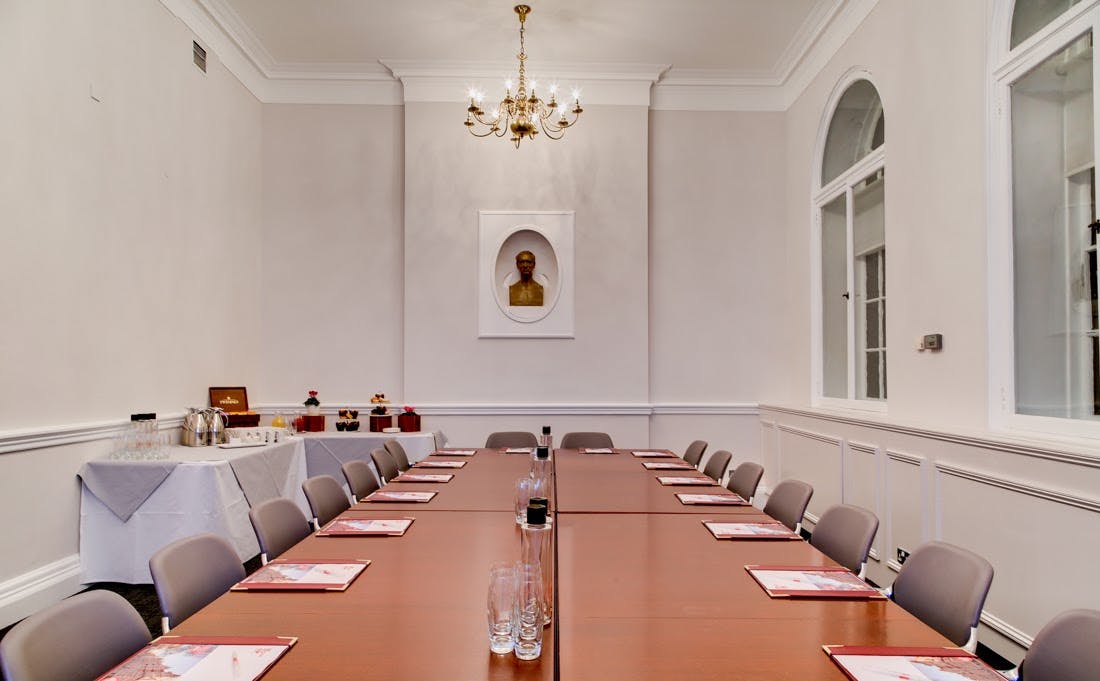 Elegant meeting room with long table, ideal for corporate events and discussions.