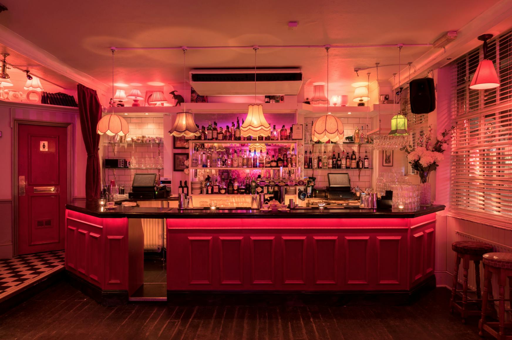 Stylish bar with pink lighting for networking events in Simmons, Soho.