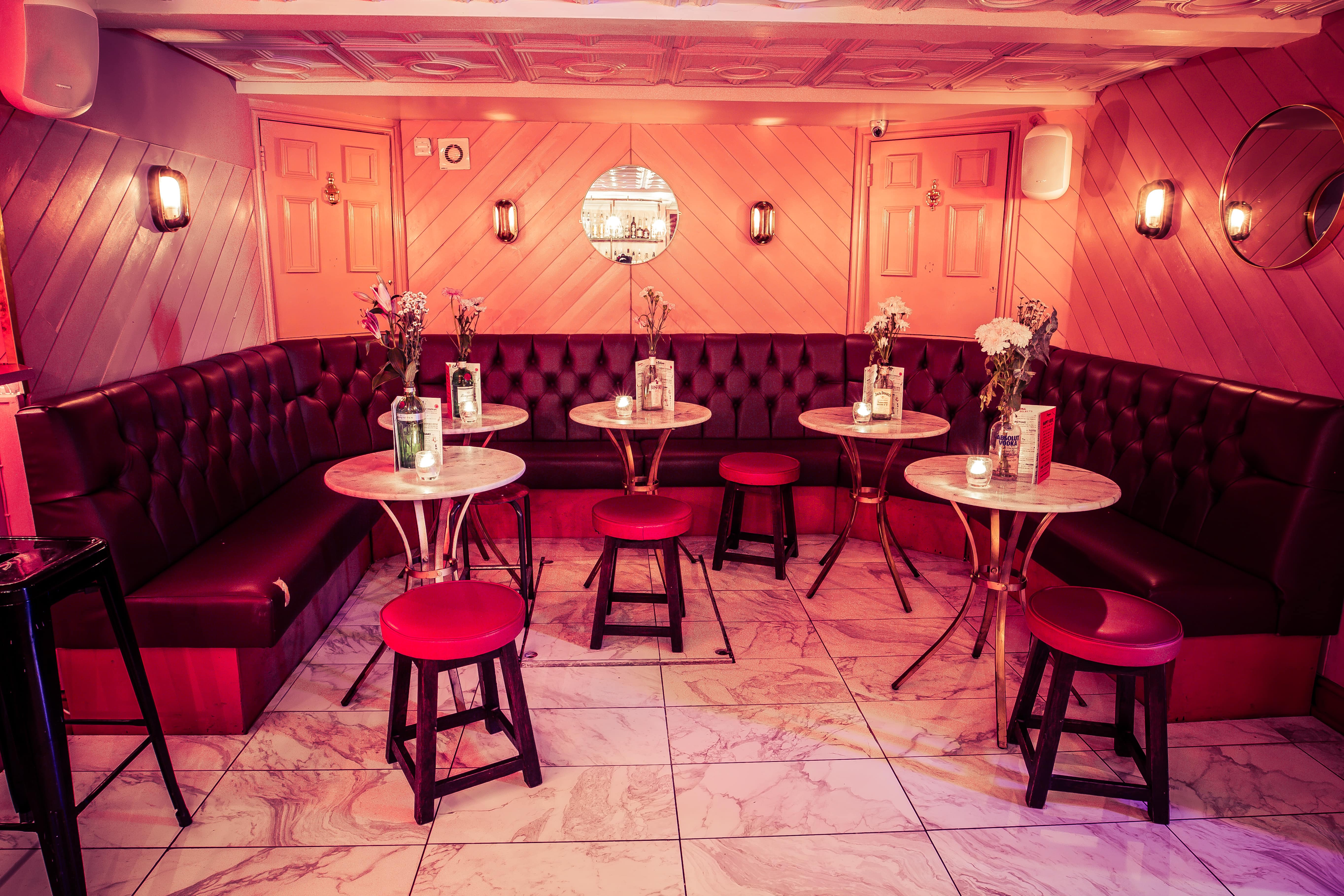 Stylish Function Room at Simmons, Liverpool Street with plush red seating for events.