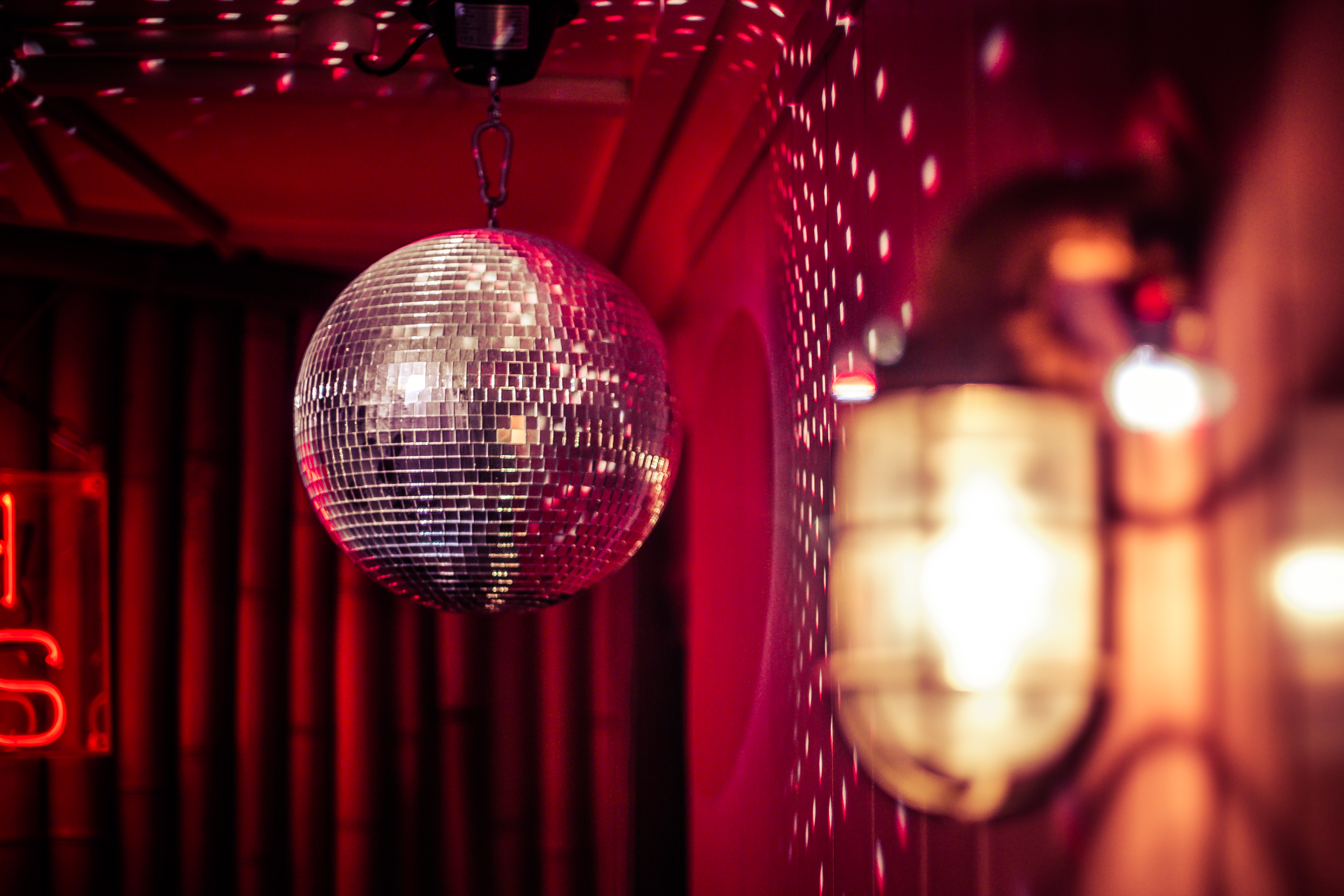 Vibrant event space at Main Bar, Simmons with disco ball for parties and networking. - Banner