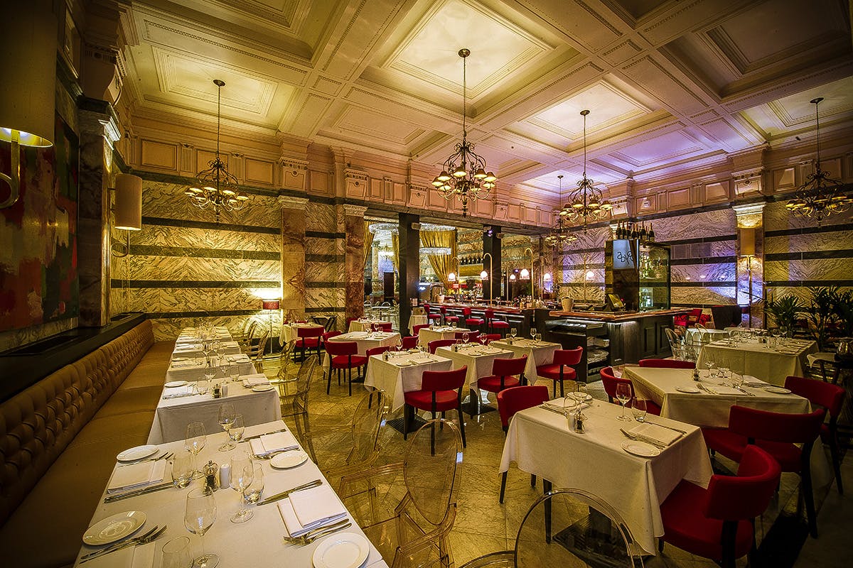 Elegant dining area with plush red chairs for upscale events at Boyds Grill & Wine Bar.