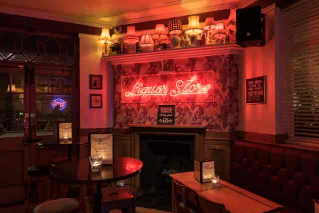 Cozy venue hire in Euston Square with neon sign, perfect for networking events and gatherings.