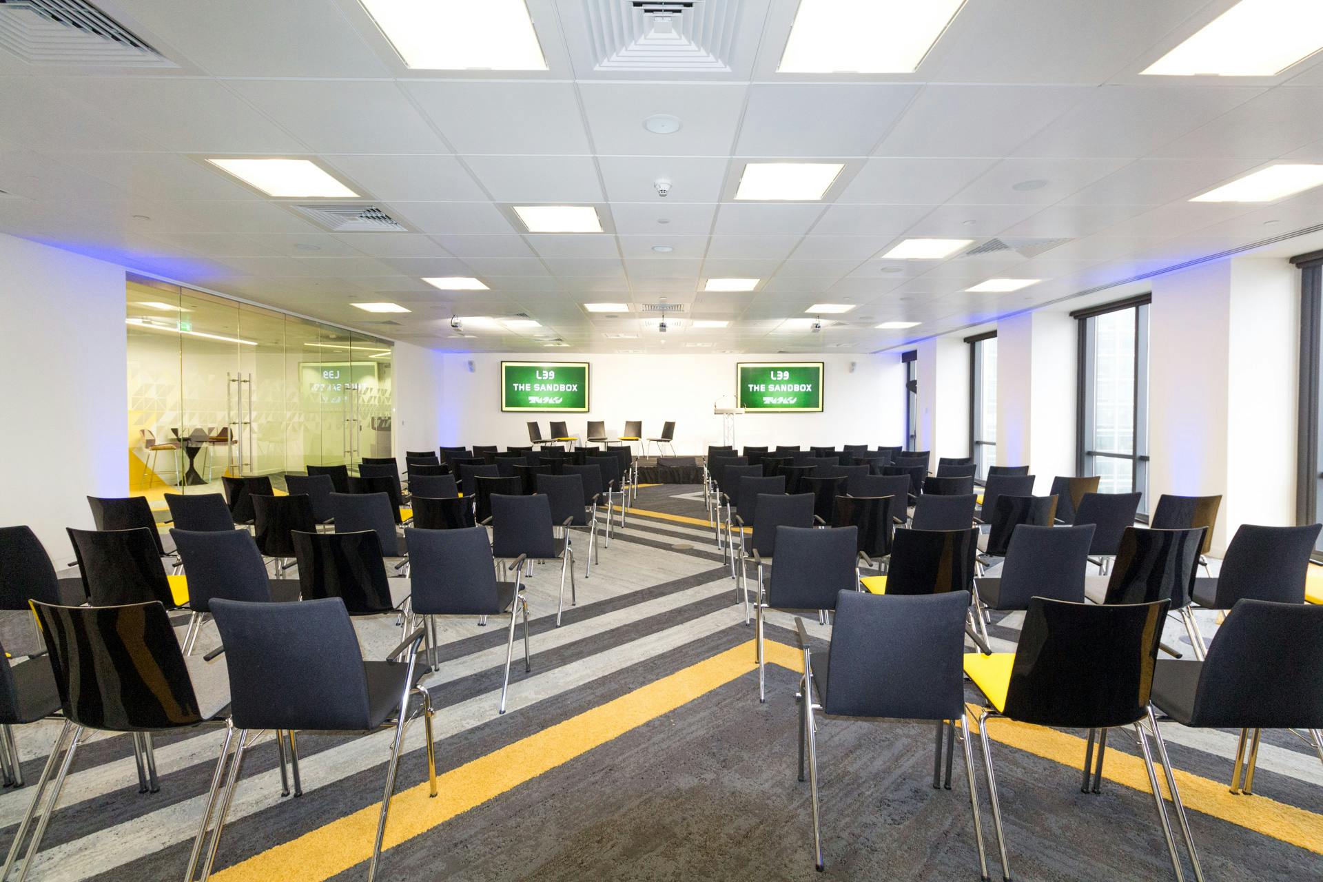 Modern event space with black chairs for corporate presentations at Level39.