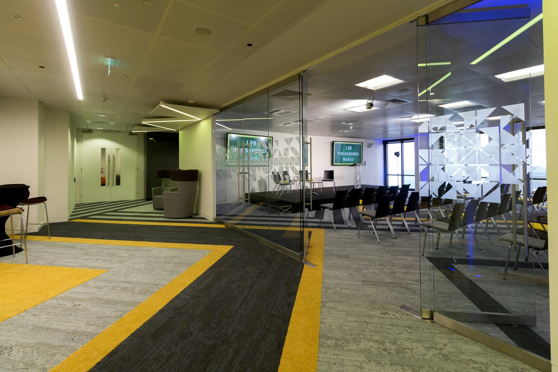 Modern meeting space with glass walls, ideal for collaboration and brainstorming events.