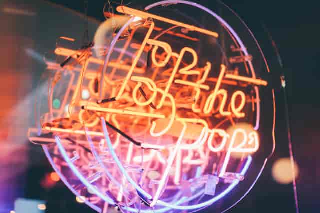 Vibrant "Pop" neon sign at Simmons Temple venue, perfect for retro-themed corporate events and parties.