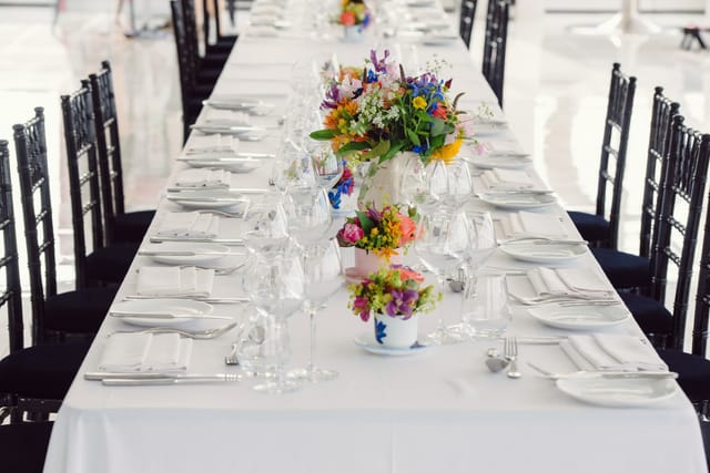 Elegant banquet table with vibrant flowers at Altitude 360 for weddings and events.