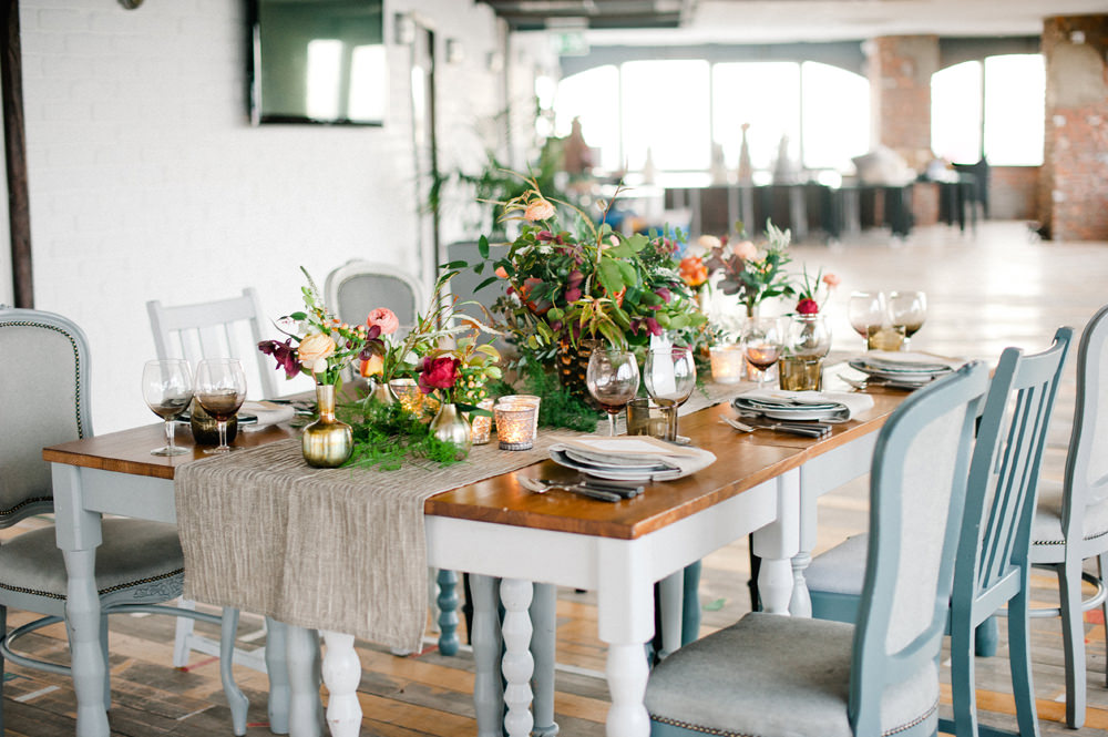 Elegant dining table setting with floral centerpieces for upscale events in London. - Banner