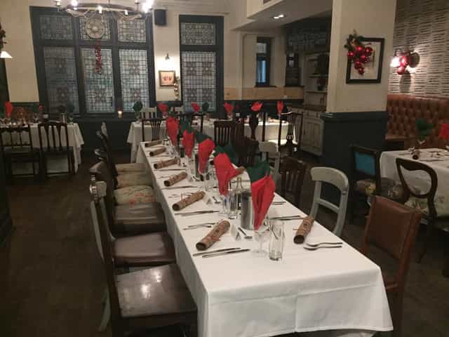 Old Bar festive holiday dining setup with banquet tables for private events.