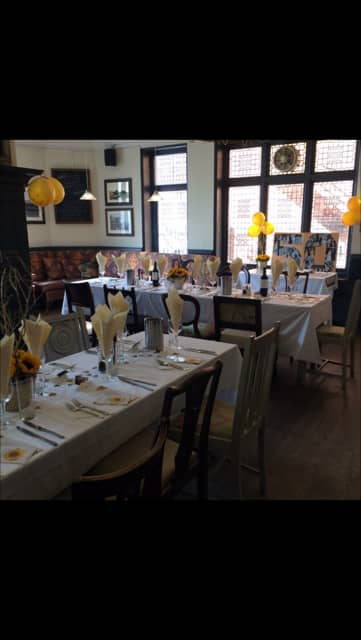 Old Bar at The Crown Hotel: sunflower-themed long-table for milestone birthday party event.