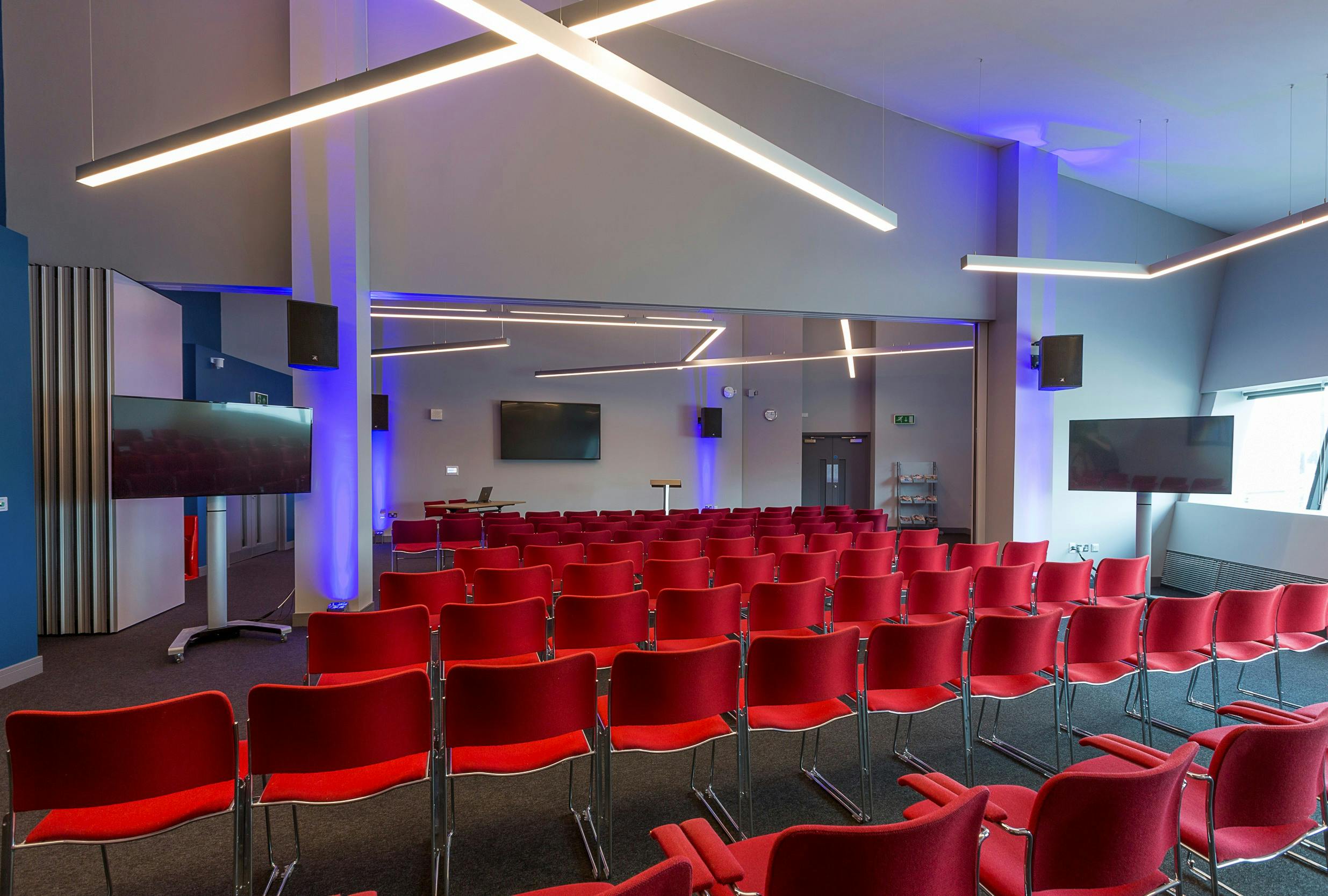 Watershard 1 event space with tiered red seating for conferences and workshops.