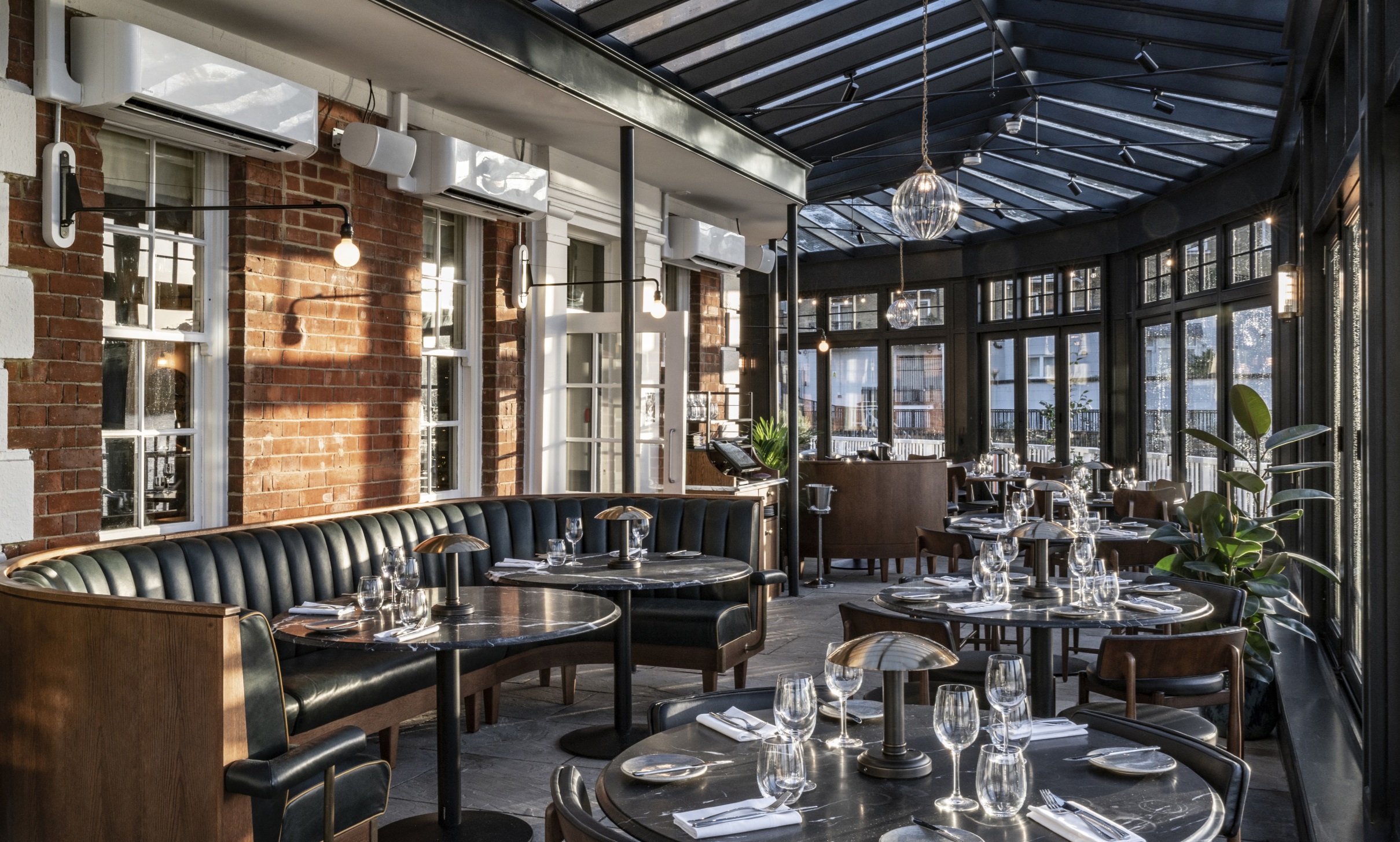 Stylish restaurant venue with large windows for corporate events and intimate gatherings. - Banner