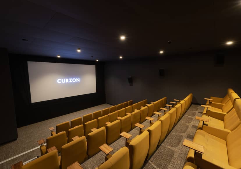 Curzon Aldgate Cinema Screen 4 with plush yellow seating for intimate film events.