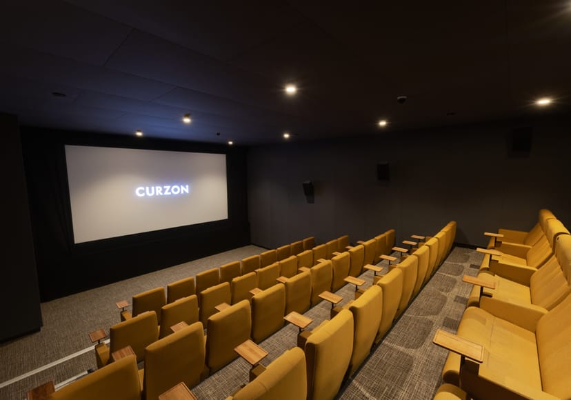 Curzon Aldgate Cinema Screen 4 with plush yellow seating for intimate film events.