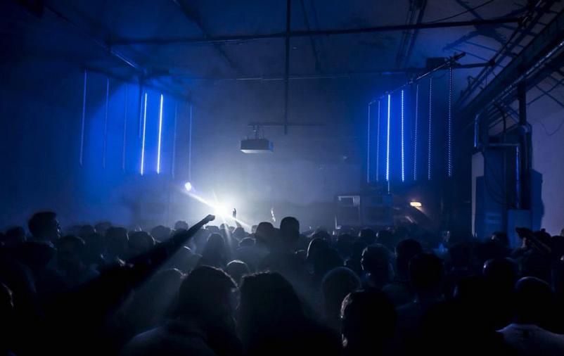 Vibrant event space with energetic crowd, ideal for concerts and nightlife. - Banner