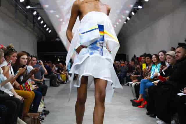 Model in striking attire on runway at The Big Black One fashion event in The Vaults.