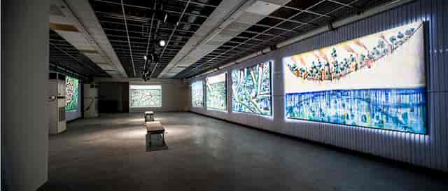 Spacious event venue with illuminated artwork, ideal for art exhibitions and corporate meetings.