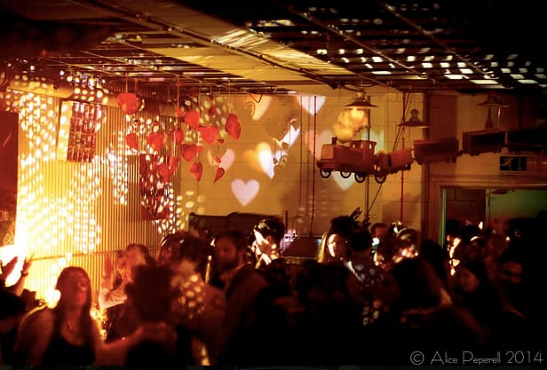 Vibrant event space with heart-shaped projections for lively celebrations and networking.