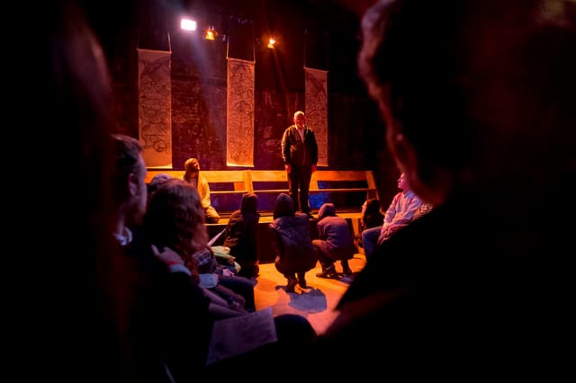 Engaging speaker at The Short Wet One workshop in warm, inviting lighting.