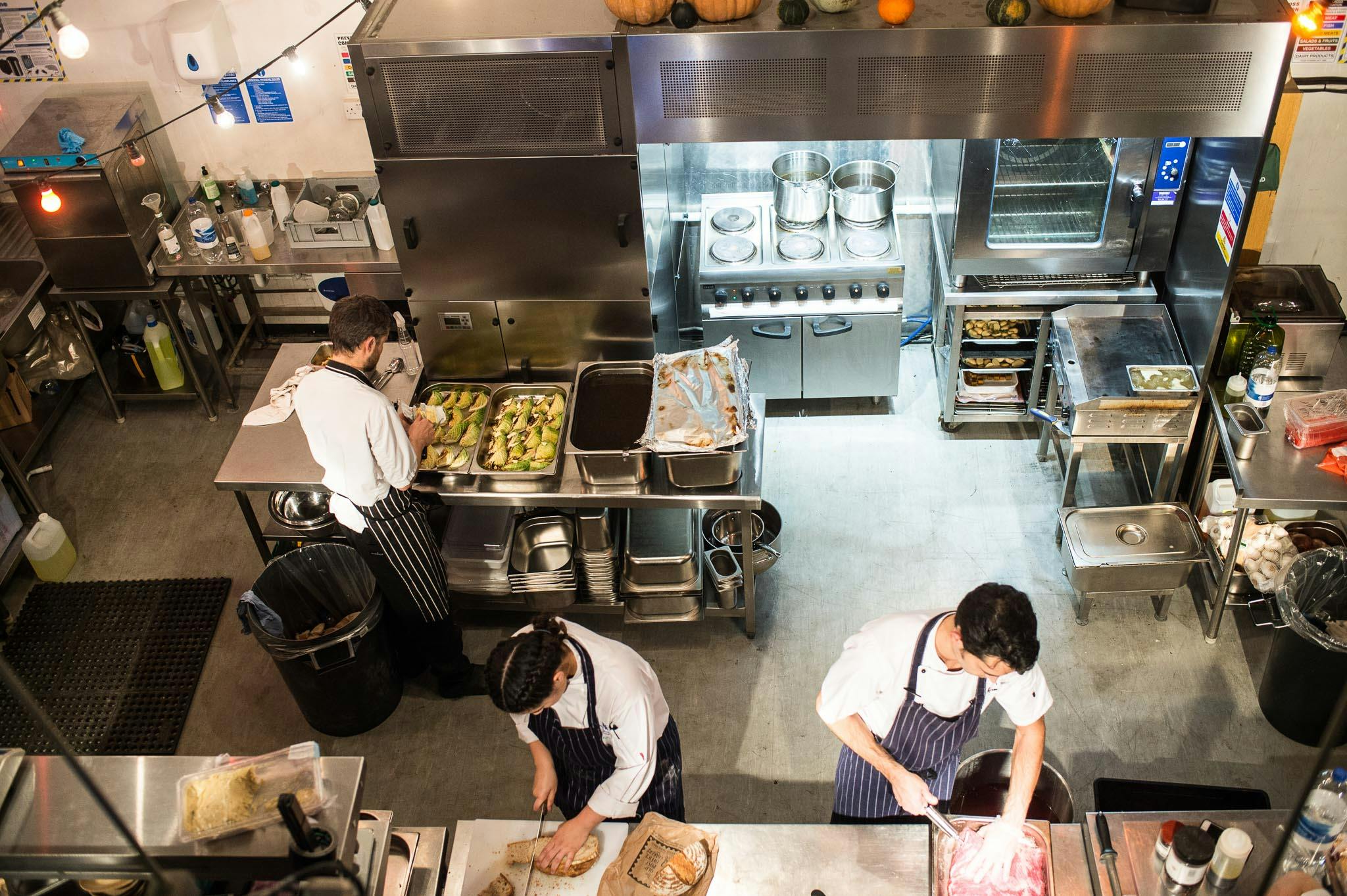 Busy commercial kitchen at The Food One, showcasing event catering teamwork and culinary skills.