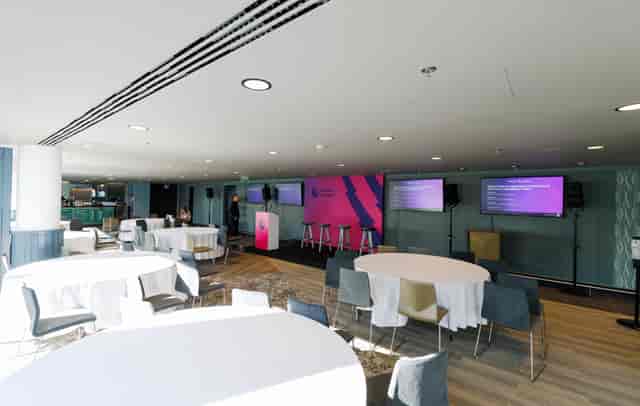 Arc Wembley Stadium conference room with branded stage for corporate events and workshops.