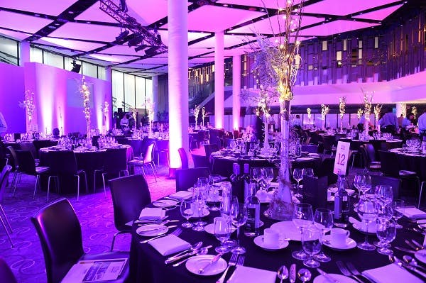 Elegant Bobby Moore Room at Wembley Stadium set for corporate gala dinner.