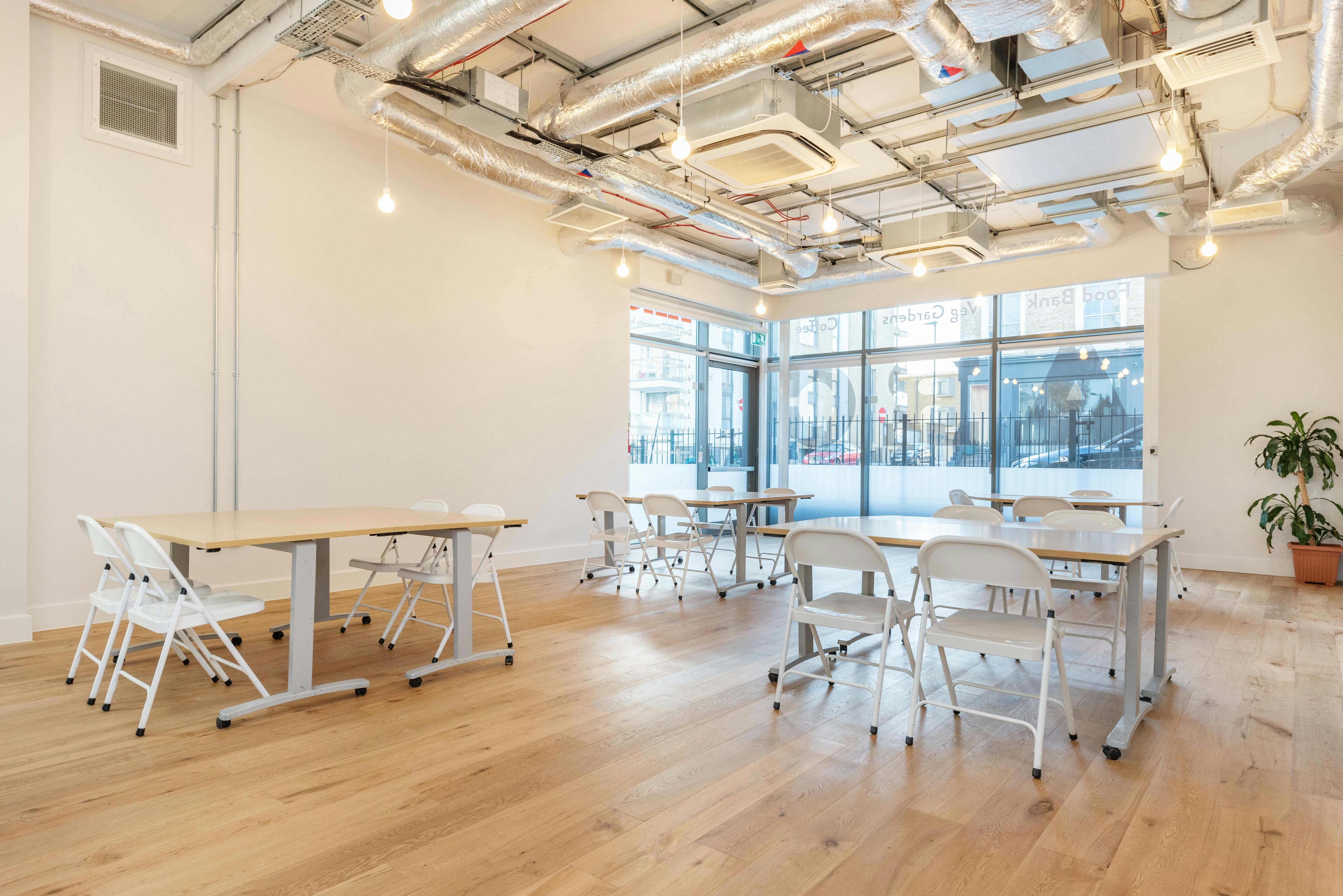 Versatile meeting room with natural light, ideal for workshops and gatherings in Islington.