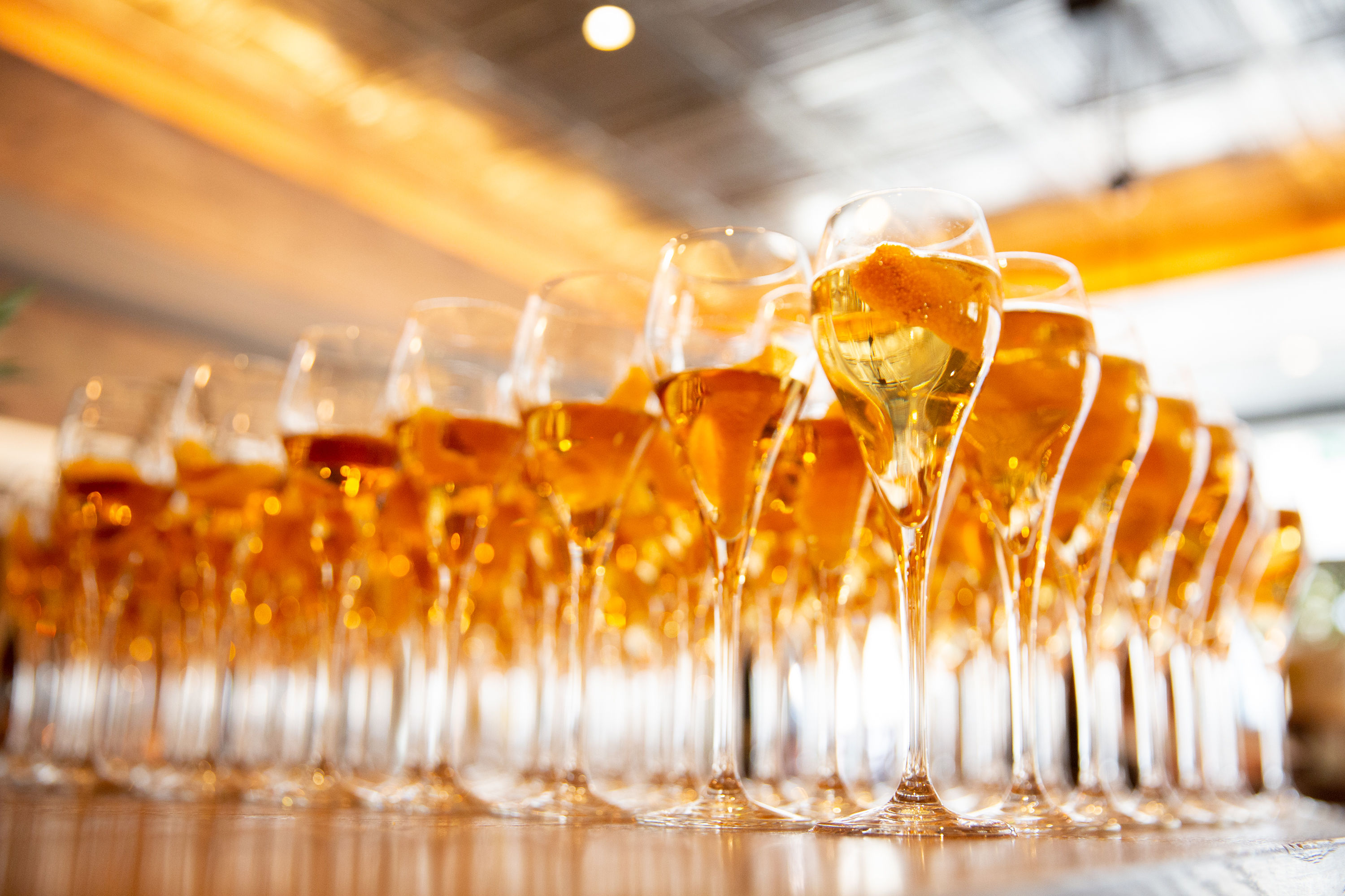 Champagne flutes at OXBO Restaurant, ideal for weddings and corporate events. - Banner