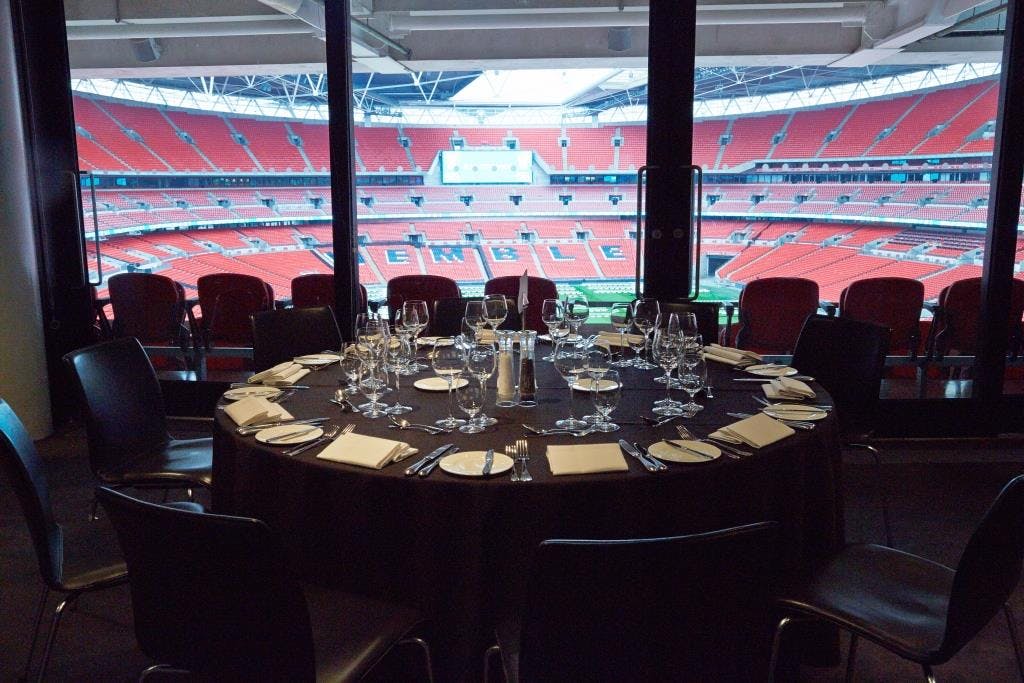 Pitch View Room at Wembley Stadium with elegant table setup for corporate events.