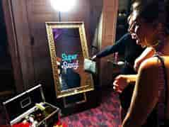 Interactive photo booth with ornate mirror at a fun event in The Coliseum Suite.