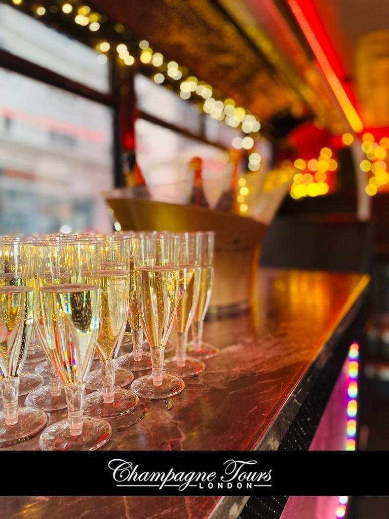 Luxury double-decker bus with champagne flutes for upscale London tours and celebrations.