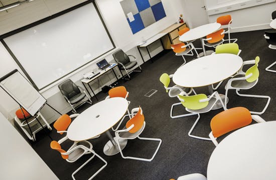 Modern Vygotsky Suite meeting room with colorful seating for workshops and presentations.