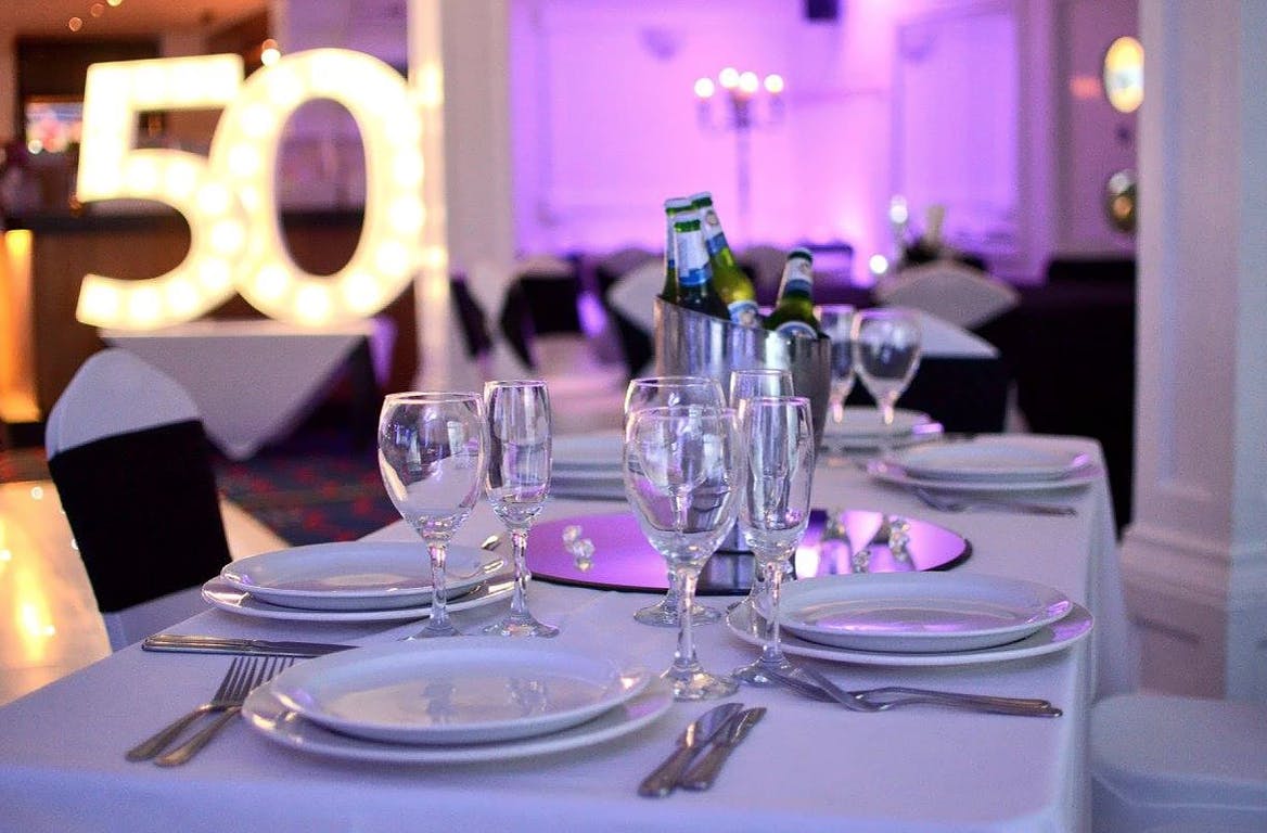 Elegant table setting for a 50th celebration at Spinnaker Function Suite, Yacht Club.