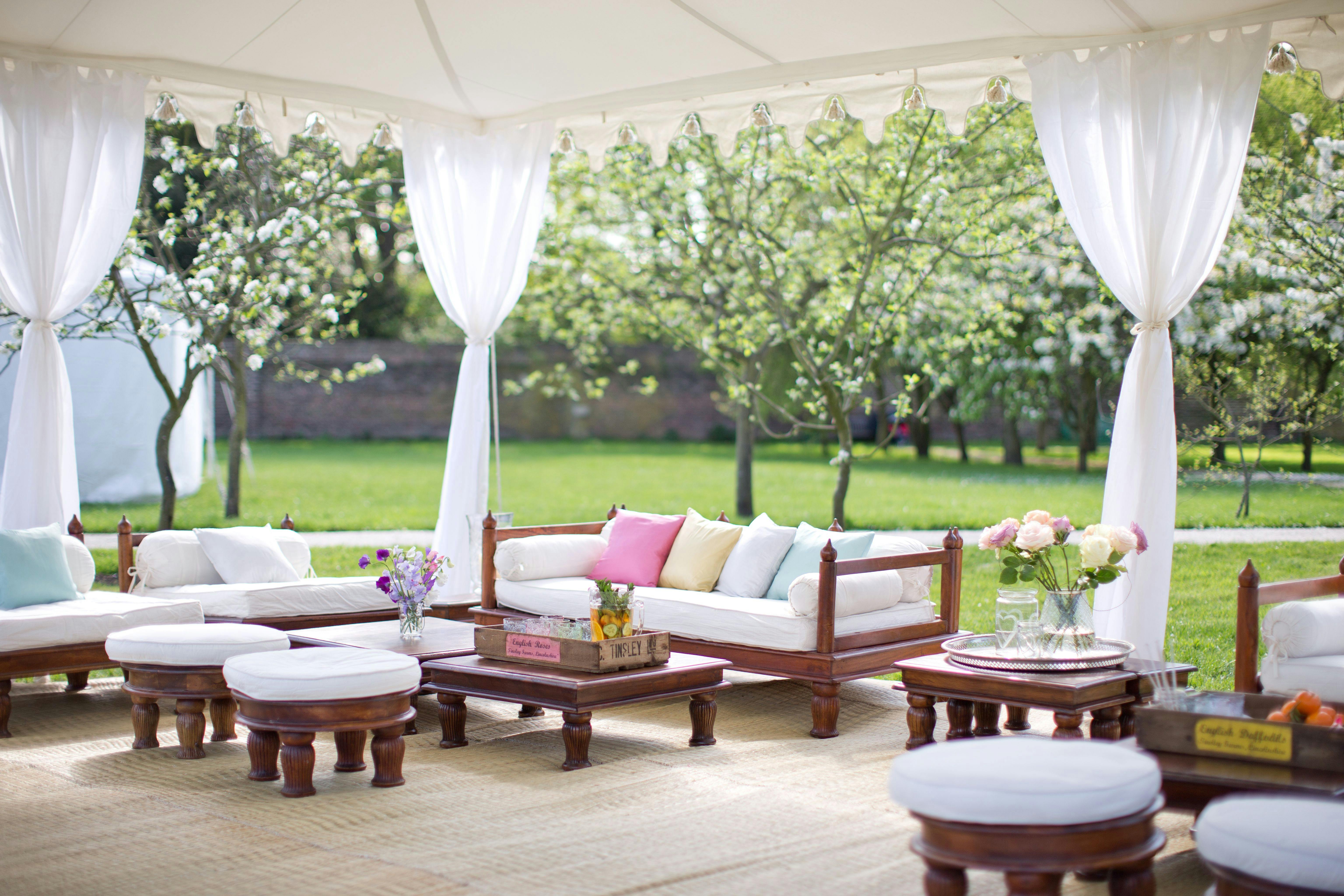 Outdoor lounge at Fulham Palace, featuring white drapery for events and networking.