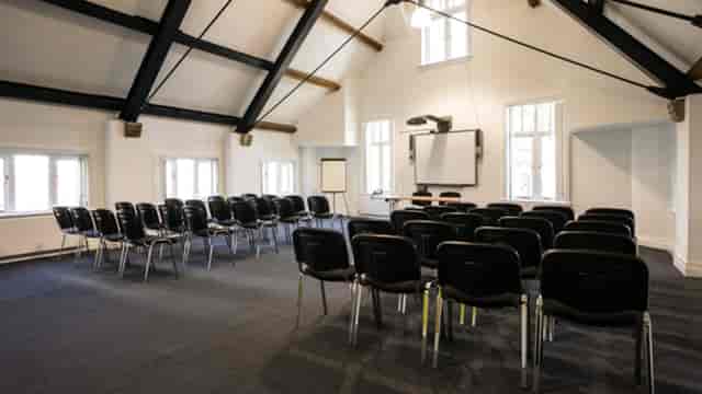 Conference Space Two at Manchester Cathedral: bright meeting room with multimedia setup.