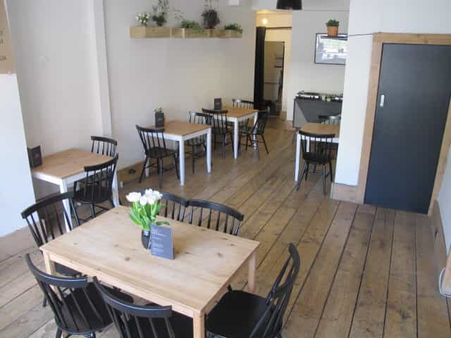 Versatile event space with wooden floors, ideal for meetings and workshops.