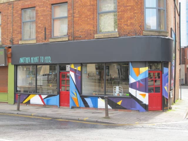 Vibrant venue with colorful mural, perfect for creative meetings and events.