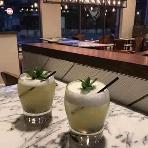 Elegant cocktails with mint garnish at Assenheims Bar & Grill for networking events.